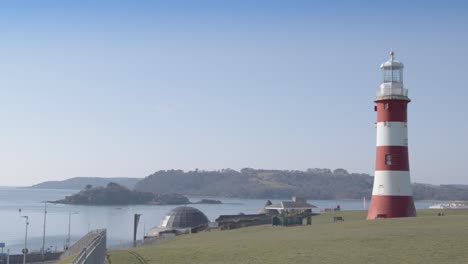 wide of smeatons tower on plymouth's hoe on a bright sunny day with a view of the sea in the background