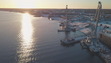 river port at sunrise/sunset with industrial activities