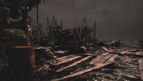 dark pier with fishing equipment and barrels during nighttime