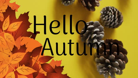 animation of hello autumn text over pine cones and autumn leaves on yellow background