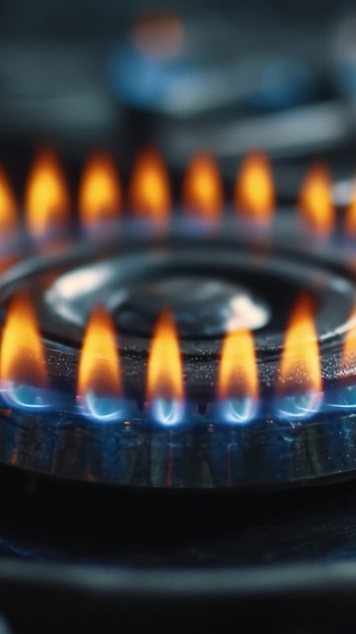 An Up-Close View of Flickering Flames on a Gas Burner, Showcasing the Intensity and Color of the Flames Illuminating the Surrounding Area in a Domestic Kitchen Setting