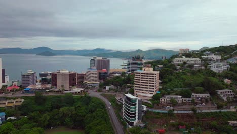 morning cloudy foggy sunrise port moresby harbour crown hotel plaza hilton ela beach papua new guinea aerial drone png walter bay rainy coral sea coastline capital city mountains forwards motion