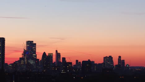 city of london skyline silhouetted at sunset. static tripod shot