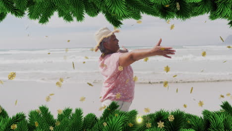 animation of christmas decorations over biracial woman on beach