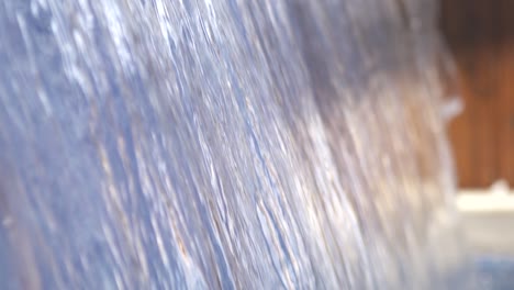 slow motion shot: fresh clean water flowing from a fountain