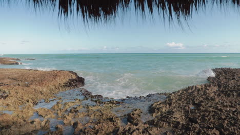 Dolly-out-shot-of-sea-with-hut-in-foreground