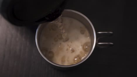 pouring in hot water inside the steel cup