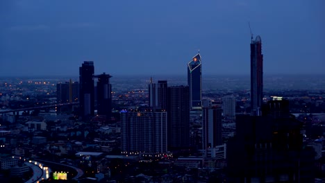 skyscrapers and highways in bangkok city at dusk, thailand