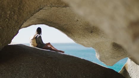 Beach,-cave-and-woman-on-an-adventure-on-vacation