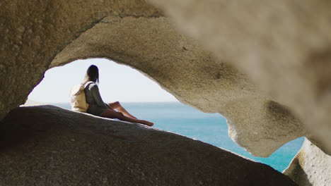 beach, cave and woman on an adventure on vacation