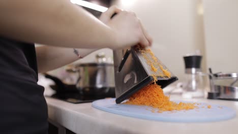 Carrots-on-a-grater-rubbed-on-the-home-kitchen.-Cutting-Carrot-Grater