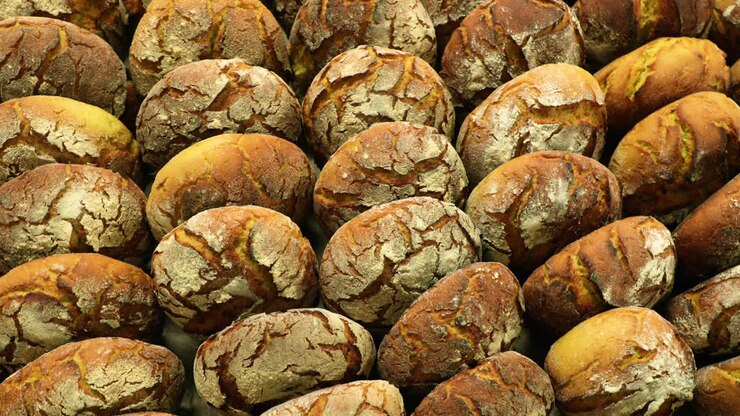 Pieces Of Sourdough Bread In A Rack - Freshly Baked In A Bakery - slow motion orbiting shot, top view