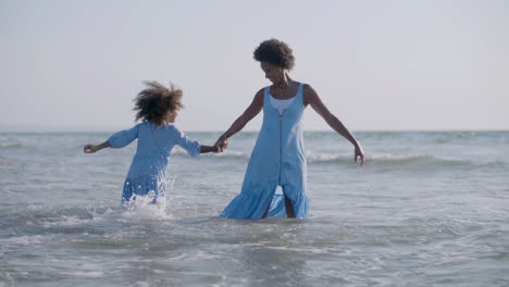 Loving-Mother-And-Her-Cute-Daughter-Playing-Together-And-Having-Fun-In-The-Sea