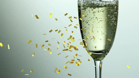 Animation-of-confetti-falling-over-champagne-glass