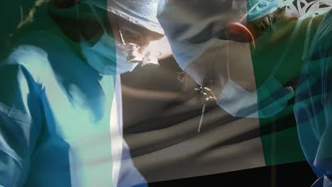 Animation-of-flag-of-nigeria-waving-over-surgeons-in-operating-theatre