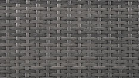camera closes in on rich wicker weave of patio chair under daylight