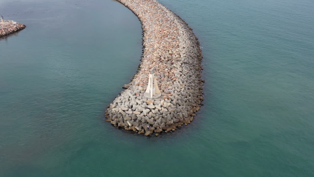 Flying slowly around a lighthouse on a levee Sete France