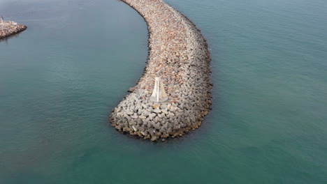 flying slowly around a lighthouse on a levee sete france