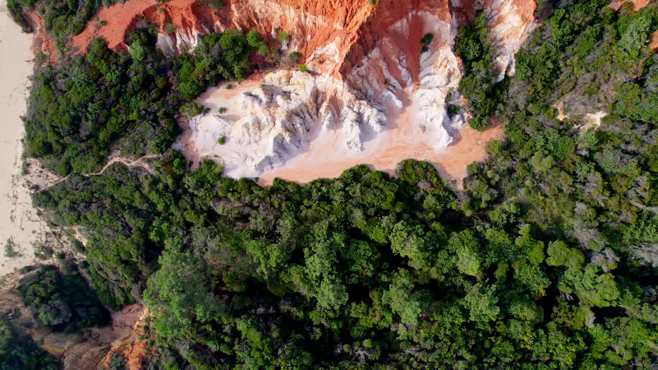Scenic top-down drone shot of the striking red and white Pinnacle cliffs in Beowa National Park, located near Pambula on the far south coast of NSW, Australia. A natural coastal wonder