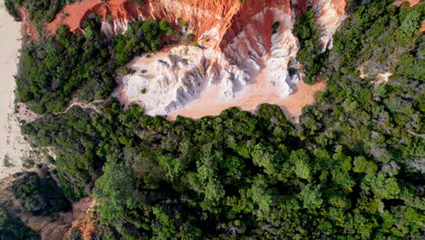 scenic top-down drone shot of the striking red and white pinnacle cliffs in beowa national park, located near pambula on the far south coast of nsw, australia. a natural coastal wonder