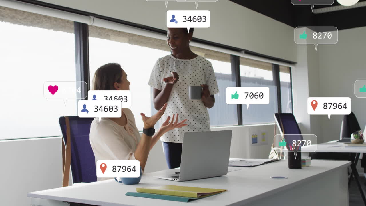 Animation of notification bars over diverse female coworkers discussing on desk in office