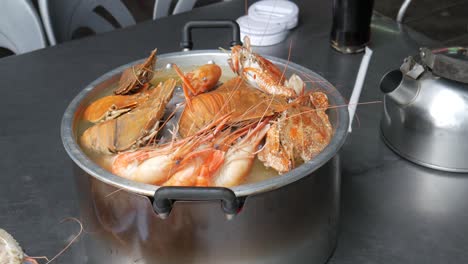 cooking slipper lobster thenus orientalis in hotpot with river prawn and blue crab