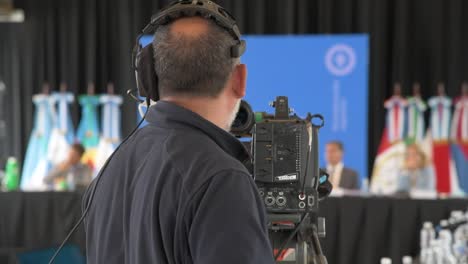 a view from the back of a cameraman in a political debates