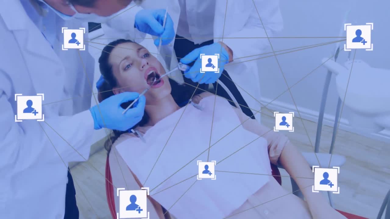 Network of digital icons over two caucasian male dentists examining female patient's teeth