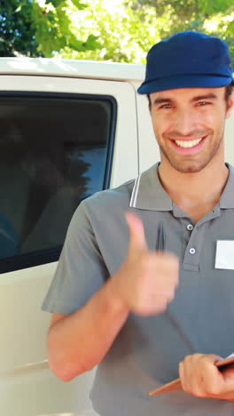 delivery man writing on clipboard