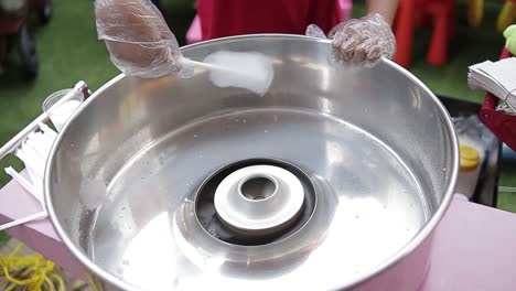 Detail-shot-of-person-making-cotton-candy-at-party,-backyard-of-house