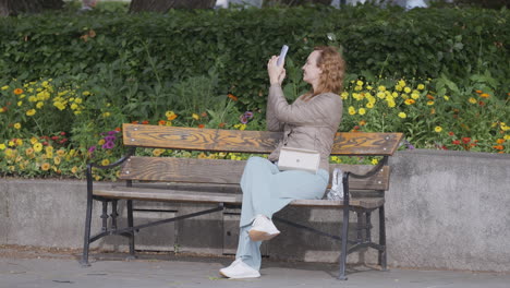 woman taking photo in park