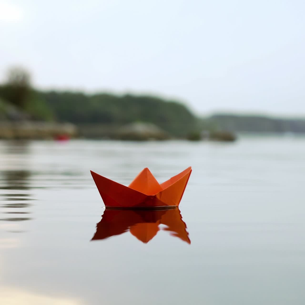 Paper boat floating on the river. Origami.