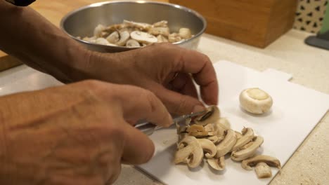 Slicing-mushrooms,-preparing-for-a-delicious-mushroom-soup---Close-up