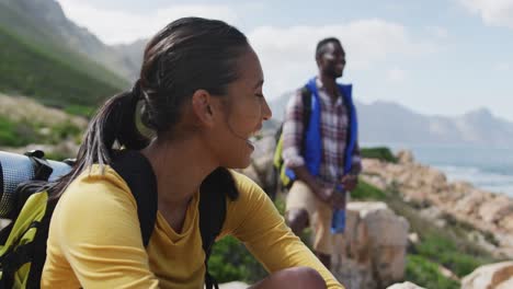 african american couple smiling and enjoying the view while hiking