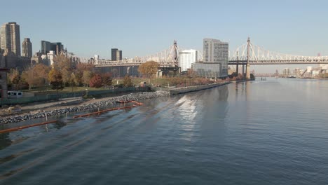 fly over east river towards ed koch queensboro bridge, new york