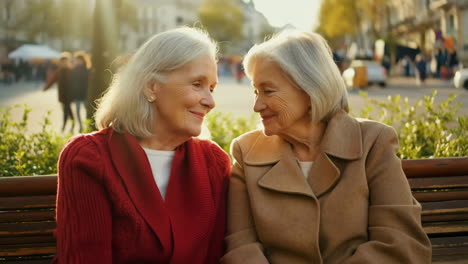 two senior women enjoying a sunny autumn day in the park