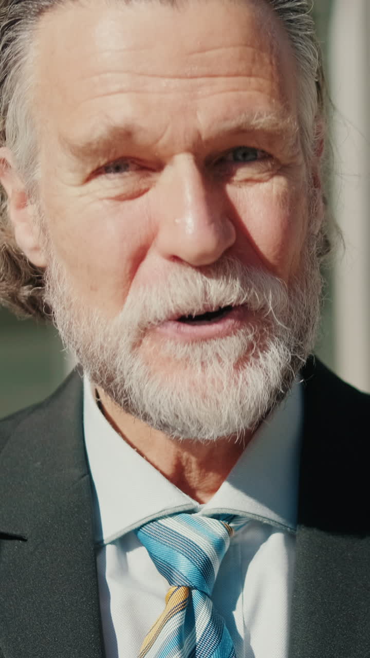 Happy Senior Businessman Smiling at Camera