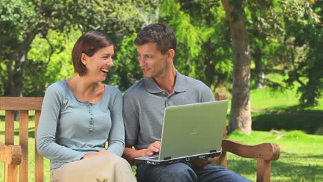 Young-couple-surfing-on-their-laptop