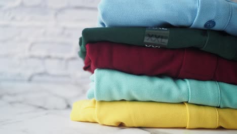 stack of colorful polo shirts