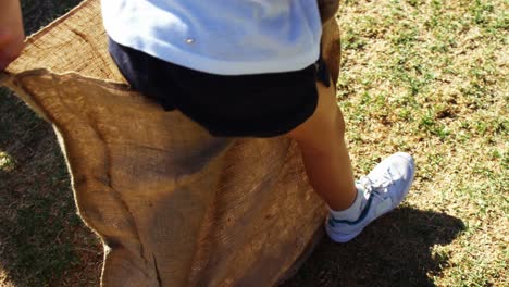 children playing a sack race in park