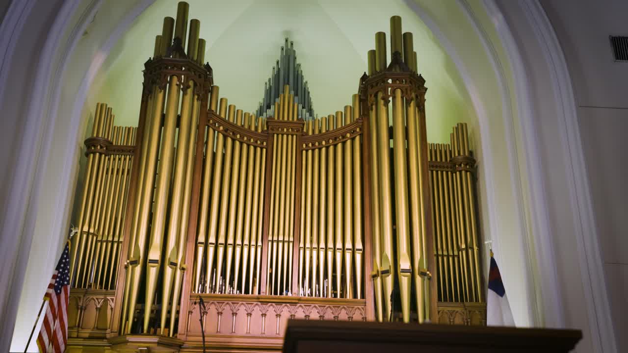 Explore the rich heritage of a church's interior, revealing its classic pews and majestic old pipe organ in intricate detail