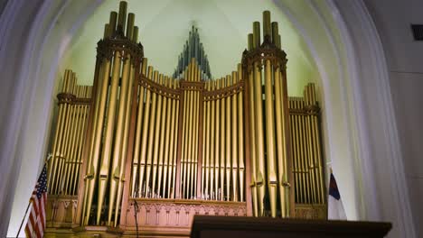 Explore the rich heritage of a church&#039;s interior, revealing its classic pews and majestic old pipe organ in intricate detail