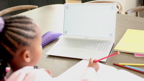 african american girl having online class using laptop with copy space, slow motion