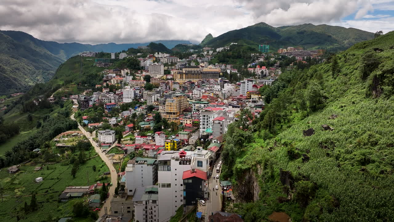 Sa Pa town surrounded by mountain landscape under the cloudy sky, Establishing drone shot
