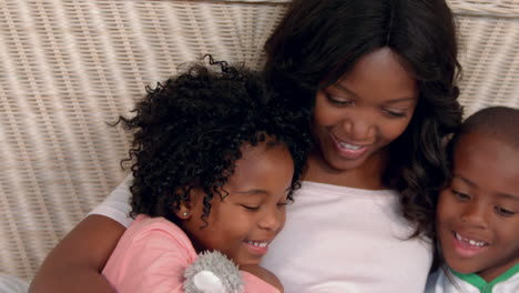 Mother-and-children-reading-in-bed