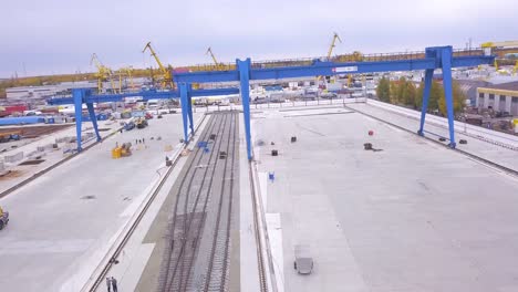 industrial area with railroad tracks and cranes