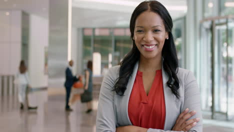 portrait of african american business woman at work in busy office lobby