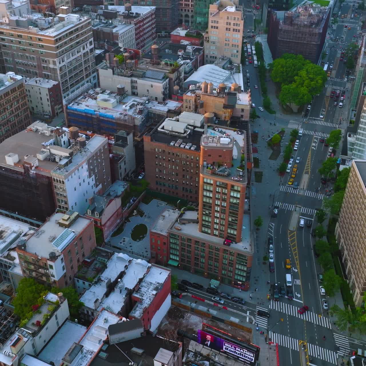 Varied roofs of with metal tanks on in New York. Lively traffic along the roads of busy never sleeping city. Top view