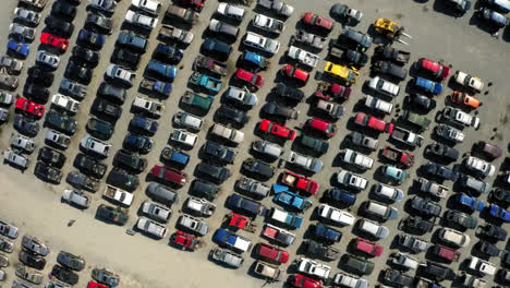 aerial view over a large junkyard full of cars