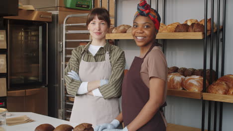 portrait of two multiethnic female coworkers in bakery